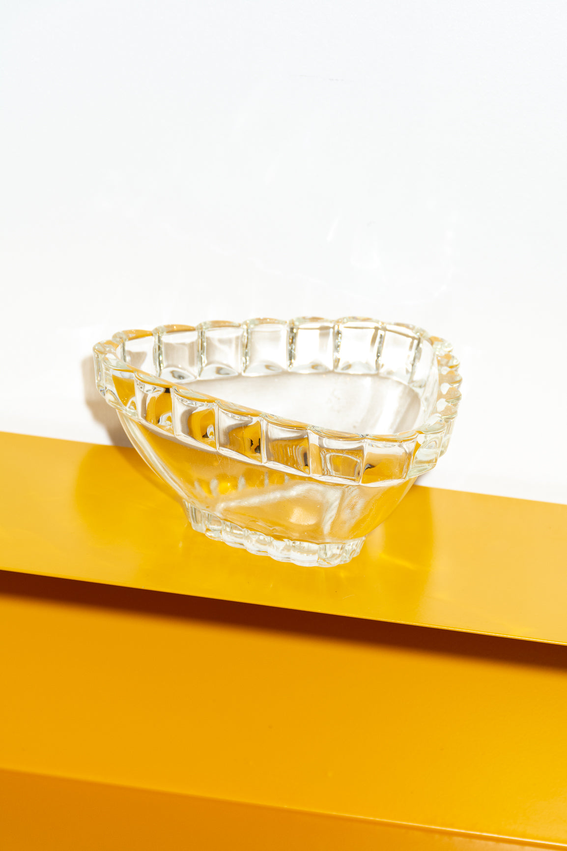 Triangular glass bowl with scalloping rim detail