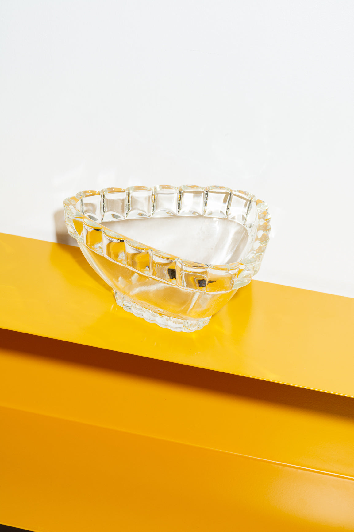 Triangular glass bowl with scalloping rim detail